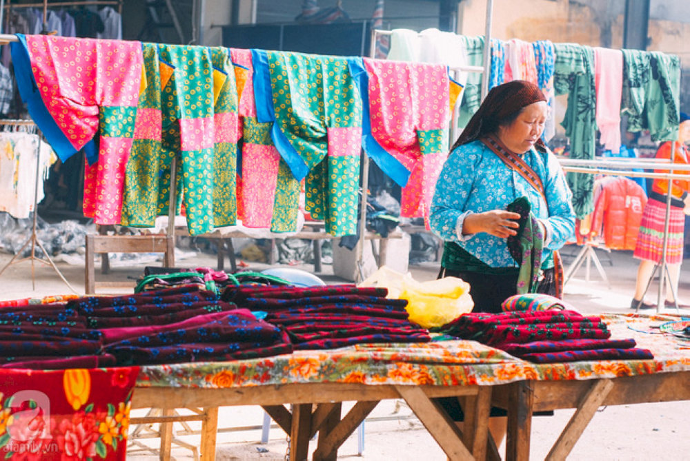 Colorful rows of fabric clothes at Meo Vac market 